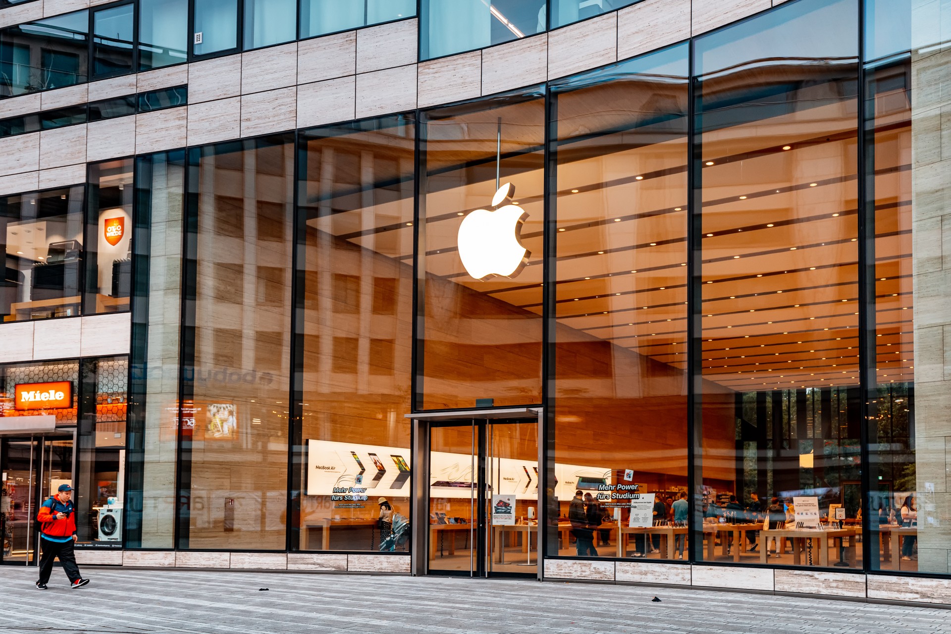 Apple logo at the entrance to the store. Buying modern iphones and electronics. Phones and macintosh at the display of the shop